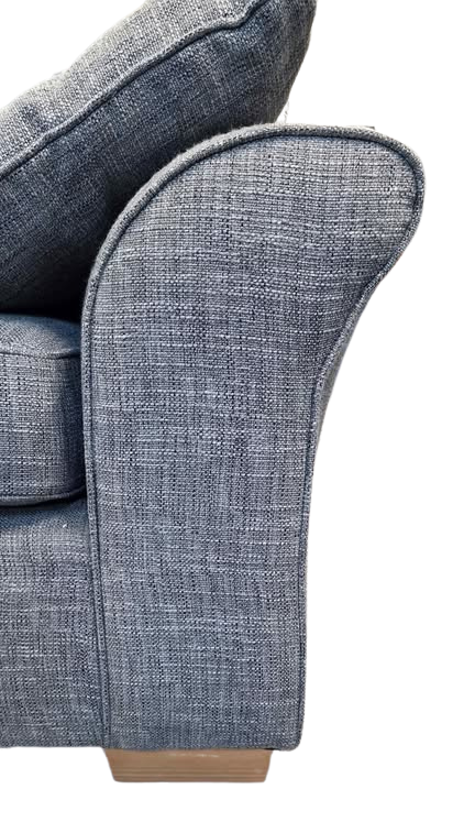 Close-up of a blue upholstered chair arm on a white background